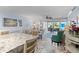 Inviting living room area with view to outdoor seating, seamlessly connected with dining space at 600 Sutton Pl # 104, Longboat Key, FL 34228