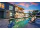 Backyard pool area featuring stunning water views, a fire feature, and seamless indoor/outdoor living at 606 Crestwood Ln, Holmes Beach, FL 34217