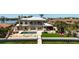 Luxury home with a backyard oasis including a pool, outdoor kitchen, and waterfront access with a dock at 606 Crestwood Ln, Holmes Beach, FL 34217
