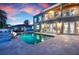Beautiful pool and patio area with waterfront views and an outdoor fire pit, perfect for entertaining at 606 Crestwood Ln, Holmes Beach, FL 34217
