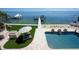 Inviting backyard featuring a sparkling pool, cozy fire pit, and stunning waterfront views at 606 Crestwood Ln, Holmes Beach, FL 34217