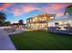 Stylish backyard with outdoor kitchen, modern fire pit, covered porch, and pool at 606 Crestwood Ln, Holmes Beach, FL 34217