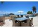Waterfront backyard with a luxurious outdoor dining and lounge area by the pool at 606 Crestwood Ln, Holmes Beach, FL 34217