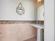 Powder room features tiled walls, and a pedestal sink with designer fixtures and decor at 606 Crestwood Ln, Holmes Beach, FL 34217