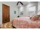 Cozy bedroom with starfish accents, wood floors, and a bright window at 606 Crestwood Ln, Holmes Beach, FL 34217