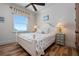 Bedroom with water view, wood floors and coastal decor at 606 Crestwood Ln, Holmes Beach, FL 34217