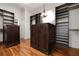 Custom walk-in closet with dark wood shelving and storage at 606 Crestwood Ln, Holmes Beach, FL 34217