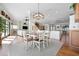 Open-concept dining room connects to a living area, showcasing a blend of comfort and style at 606 Crestwood Ln, Holmes Beach, FL 34217