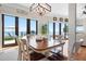 Inviting dining room featuring a wooden table with views of the water and outdoor seating area at 606 Crestwood Ln, Holmes Beach, FL 34217