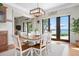 Charming dining area with a wooden table, seating for six, and views of the waterfront at 606 Crestwood Ln, Holmes Beach, FL 34217