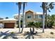 Charming home featuring an oversized garage, lush landscaping, and beautiful stonework at 606 Crestwood Ln, Holmes Beach, FL 34217