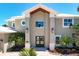 Elegant home featuring a grand entrance, beautiful stonework, and manicured landscaping at 606 Crestwood Ln, Holmes Beach, FL 34217