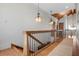 Well-lit hallway with hardwood floors, decorative lighting, and wooden details at 606 Crestwood Ln, Holmes Beach, FL 34217