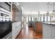 Gourmet kitchen boasts modern appliances, wood flooring, and views of the outdoor living space at 606 Crestwood Ln, Holmes Beach, FL 34217