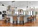 Spacious kitchen featuring a large island, stainless steel appliances, and stylish pendant lighting at 606 Crestwood Ln, Holmes Beach, FL 34217