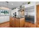 Spacious kitchen with a large island, stainless steel appliances, and wooden floors at 606 Crestwood Ln, Holmes Beach, FL 34217