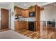 Bright kitchenette features wooden cabinetry, mosaic backsplash, and stainless steel appliances at 606 Crestwood Ln, Holmes Beach, FL 34217
