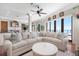 Bright living room with a comfortable sectional sofa and beautiful views of the water at 606 Crestwood Ln, Holmes Beach, FL 34217