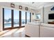 Inviting living room with direct access to the pool area, offering stunning water views at 606 Crestwood Ln, Holmes Beach, FL 34217