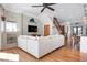 Comfortable living room adjacent to a wooden staircase, featuring stylish décor and natural light at 606 Crestwood Ln, Holmes Beach, FL 34217