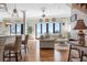 Bright living room with water views, open to the kitchen, and comfortable seating arrangement at 606 Crestwood Ln, Holmes Beach, FL 34217