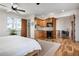 Bright bedroom features a kitchenette with wooden cabinetry, mosaic backsplash, and stainless steel appliances at 606 Crestwood Ln, Holmes Beach, FL 34217