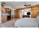 Bright bedroom features a kitchenette with wooden cabinetry, mosaic backsplash, and stainless steel appliances at 606 Crestwood Ln, Holmes Beach, FL 34217