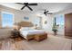 Bright main bedroom boasts a wicker bed frame, ceiling fan, and charming beachy decor at 606 Crestwood Ln, Holmes Beach, FL 34217