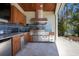 Gourmet outdoor kitchen features stainless steel appliances, granite countertops, and ample cabinetry at 606 Crestwood Ln, Holmes Beach, FL 34217