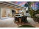 Entertain in this outdoor kitchen featuring stainless steel appliances and bar seating at 606 Crestwood Ln, Holmes Beach, FL 34217