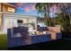 Beautiful patio area with built in benches and fire pit at dusk at 606 Crestwood Ln, Holmes Beach, FL 34217