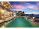 Relaxing waterfront pool area with ample seating and serene views of the water and private dock at 606 Crestwood Ln, Holmes Beach, FL 34217