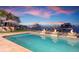 Enjoy a waterfront pool with fire bowls and ample seating areas at sunset at 606 Crestwood Ln, Holmes Beach, FL 34217