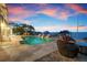 Inviting pool and patio with waterfront views, a lush lawn and a private boat dock at 606 Crestwood Ln, Holmes Beach, FL 34217