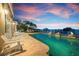 Tranquil pool and patio space with views of the waterfront, ideal for relaxation and entertainment at 606 Crestwood Ln, Holmes Beach, FL 34217
