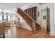 Elegant wooden staircase featuring a wine rack, and views into the living room at 606 Crestwood Ln, Holmes Beach, FL 34217