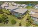 Aerial view of screened pool and backyard, showcasing the property's privacy and outdoor space within the community at 6172 Lungo Lago Dr, Sarasota, FL 34241