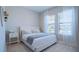 Comfortable bedroom featuring a plush king-sized bed, bedside table, and natural lighting for a relaxing ambiance at 6172 Lungo Lago Dr, Sarasota, FL 34241
