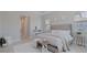 Stylishly decorated main bedroom with ample light, neutral tones, and a tufted headboard, creating a peaceful retreat at 6172 Lungo Lago Dr, Sarasota, FL 34241