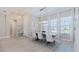 Elegant dining area with a pendant light fixture and large windows at 6172 Lungo Lago Dr, Sarasota, FL 34241