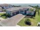 Stunning single-story home with a tile roof, paver driveway, two-car garage, and beautifully landscaped yard at 6172 Lungo Lago Dr, Sarasota, FL 34241