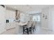Bright kitchen featuring white cabinets, a kitchen island, and modern appliances at 6172 Lungo Lago Dr, Sarasota, FL 34241