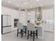 Spacious kitchen with white cabinets, stainless steel appliances, and pendant lighting at 6172 Lungo Lago Dr, Sarasota, FL 34241