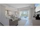 Open-concept living room with ample seating and access to the screened in patio at 6172 Lungo Lago Dr, Sarasota, FL 34241