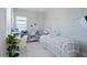 Bright office space with a desk, a medical bed, shelving, and natural light at 6172 Lungo Lago Dr, Sarasota, FL 34241