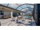 Screened-in patio with dining and relaxing seating looking out to the pool and backyard at 6172 Lungo Lago Dr, Sarasota, FL 34241