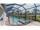 Screened-in pool area with a relaxing pool and attached spa at 6172 Lungo Lago Dr, Sarasota, FL 34241