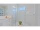 Contemporary shower with marble-look tiles and glass enclosure, complementing the bathroom's luxurious design at 6172 Lungo Lago Dr, Sarasota, FL 34241