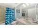 Bathroom featuring a vanity, toilet, and tub with a shower and stylish shark-themed curtain at 6410 Rosehill Farm Run, Bradenton, FL 34211