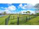Community dog park with lush grass, a bench, fence, and mature trees, perfect for pet owners and their furry friends at 6410 Rosehill Farm Run, Bradenton, FL 34211